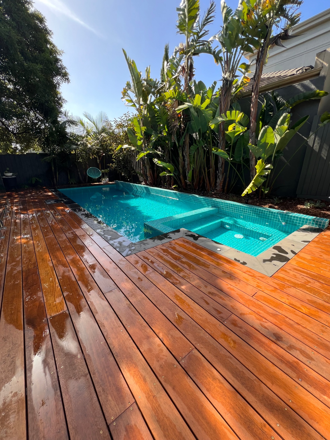 Wide-board Merbau timber decking around inground pool and spa in Melbourne — installed by Deck It Out Decks